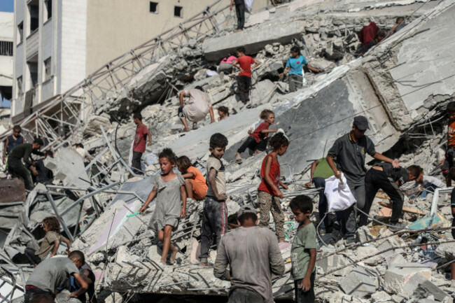 gaza-6th-sep-2025-palestinians-are-seen-near-a-destroyed-tower-following-an-israeli-airstrike-in-gaza-city-on-sept-6-2025-the-israeli-army-destroyed-a-15-floor-residential-tower-in-gaza-city-on