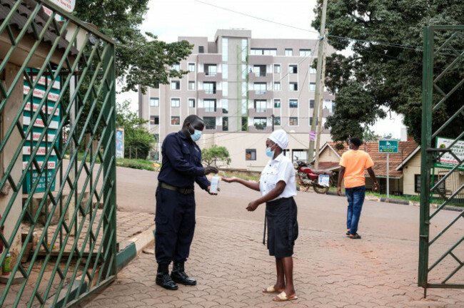 a-woman-sanitises-her-hands-in-front-of-kibuli-muslim-hospital-in-kampala-uganda-saturday-may-16-2026-ap-photo-hajarah-nalwadda