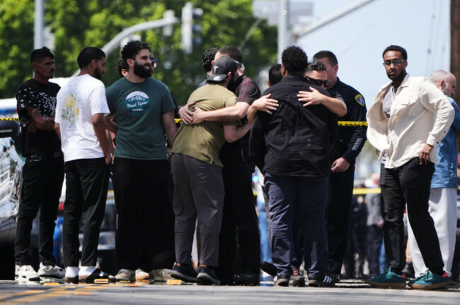 people-embrace-near-the-scene-of-a-shooting-outside-the-islamic-center-of-san-diego-monday-may-18-2026-in-san-diego-ap-photogregory-bull
