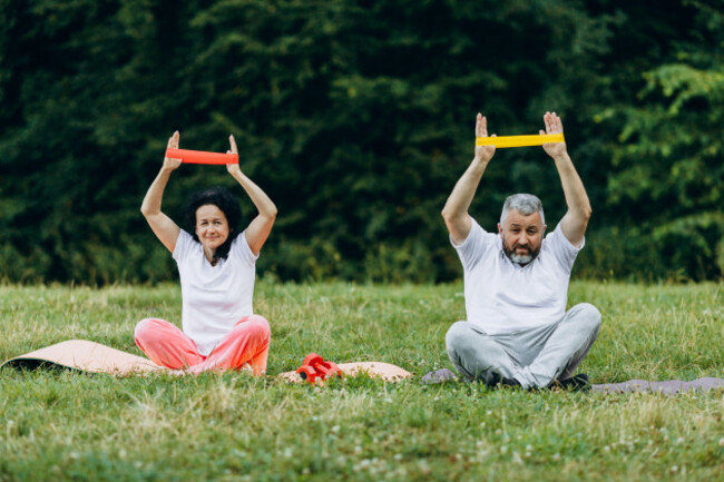 middle-age-woman-and-man-taking-exercise-with-a-tape-together-concept-sport-image