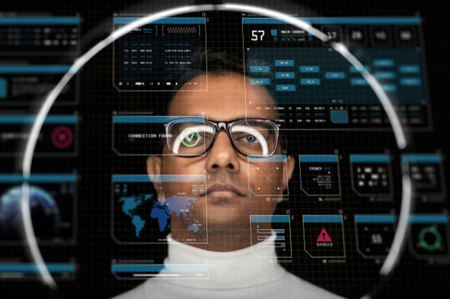 man-in-glasses-with-white-illumination-over-black