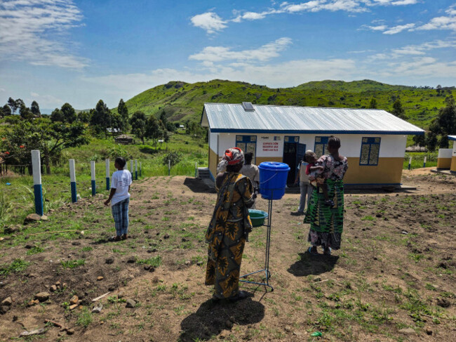 1 Women washing their hands when enterring the safe space built by a major donor in Zaba