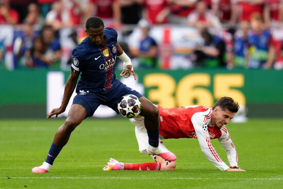 paris-saint-germains-willian-pacho-left-and-arsenals-kai-havertz-battle-for-the-ball-during-the-uefa-champions-league-final-at-the-puskas-arena-budapest-picture-date-saturday-may-30-2026
