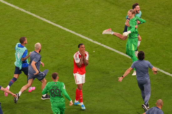 psg-players-celebrate-while-arsenals-gabriel-magalhaes-centre-reacts-after-failing-to-score-during-a-penalty-shootout-after-extra-time-during-the-champions-league-final-soccer-match-between-paris-s