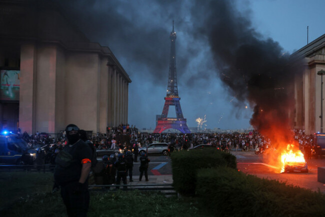 a-car-burns-and-fireworks-explode-as-police-watch-psg-supporters-celebrate-in-paris-saturday-may-30-2026-after-the-champions-league-final-soccer-match-between-paris-saint-germain-and-arsenal-thats