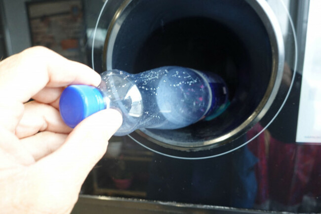 symbolic-image-return-machine-for-pet-deposit-bottles-mans-hand-throws-a-pet-bottle-into-a-machine