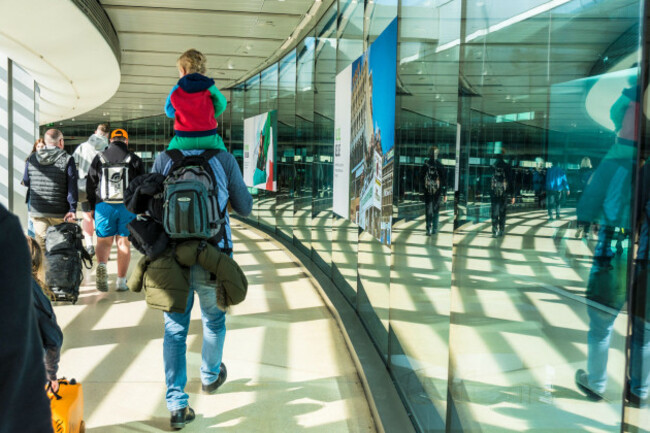 passengers-and-a-man-carrying-a-young-child-at-dublin-airport-ireland