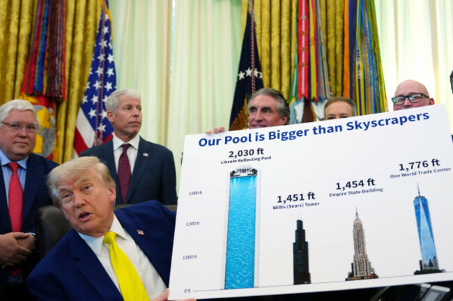 president-donald-trump-holds-a-poster-as-he-speaks-at-an-event-about-coal-as-west-virginia-gov-patrick-morrisey-from-left-energy-secretary-chris-wright-interior-secretary-doug-burgum-environment