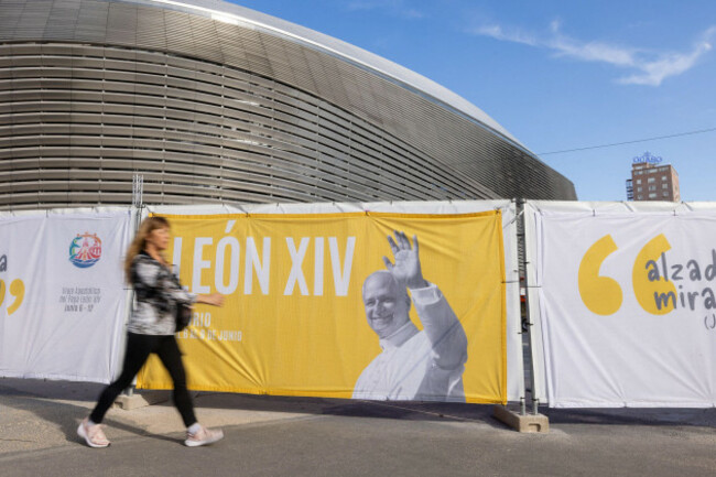 madrid-spain-5th-june-2026-people-walk-past-a-banner-featuring-pope-leo-xiv-ahead-of-his-visit-to-madrid-credit-image-marek-ladzinskizuma-press-wire-editorial-usage-only-not-for-commer