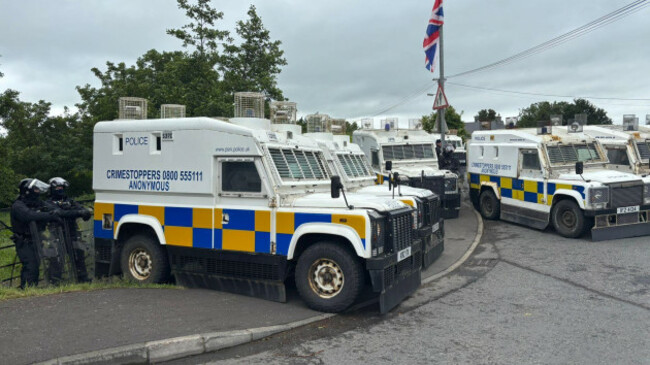 police-service-of-northern-ireland-psni-officers-in-riot-gear-with-armoured-vans-monitor-protesters-in-scarva-co-down-during-a-pro-palestinian-march-from-lurgan-to-newry-that-will-pass-through-the