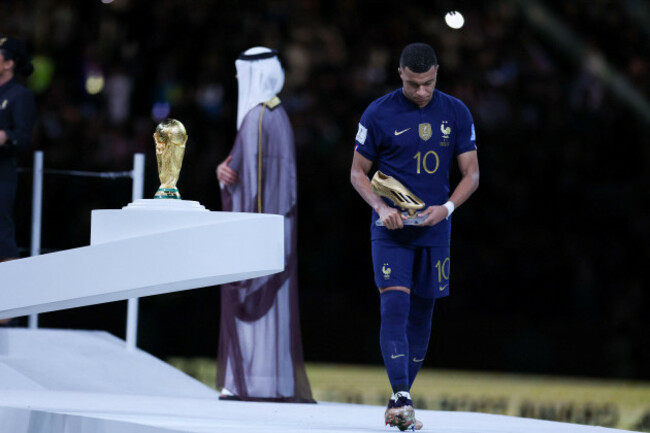 december-18-2022-doha-qatar-frances-forward-10-kylian-mbappe-looks-at-the-trophy-after-receiving-the-silver-medal-during-the-qatar-2022-world-cup-trophy-ceremony-after-losing-the-football-final