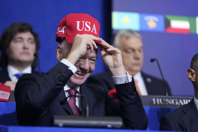 giovanni-vincenzo-infantino-president-of-fifa-tries-out-a-usa-hat-during-a-board-of-peace-meeting-at-the-u-s-institute-of-peace-thursday-feb-19-2026-in-washington-ap-photomark-schiefelbein