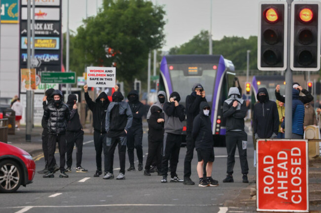 a-crowd-of-protesters-gathers-in-the-road-following-a-stabbing-incident-in-north-belfast-tuesday-june-9-2026-the-stabbing-took-place-late-monday-ap-photopeter-morrison