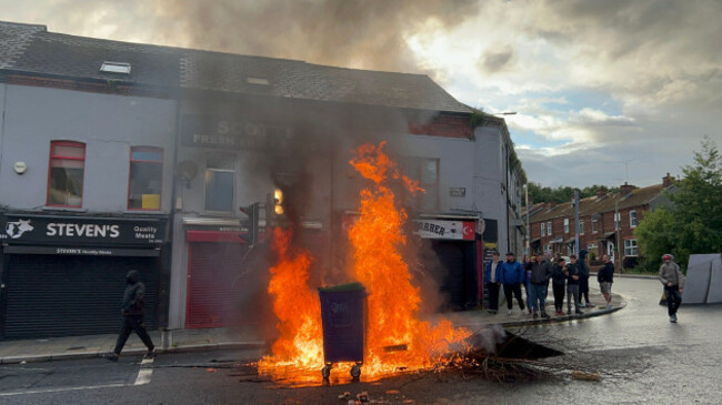 bins-set-alight-by-protesters-on-the-crumlin-road-area-of-belfast-as-disorder-flared-during-an-anti-immigration-demonstration-organised-in-response-to-monday-nights-stabbing-attack-in-the-city-a-30