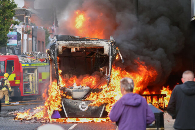 people-watch-as-firemen-arrive-to-put-out-vehicle-that-was-set-alight-during-a-protest-in-east-belfast-following-a-stabbing-incident-in-belfast-tuesday-june-9-2026-ap-photopeter-morrison