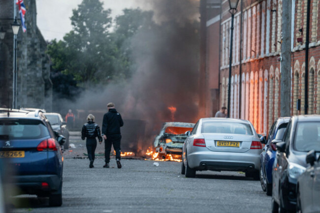 belfast-uk-09th-june-2026-one-of-many-cars-firebombed-during-an-anti-immigration-protest-belfast-erupted-into-flames-as-locals-took-to-the-streets-to-protest-against-the-stabbing-of-a-north-belfa