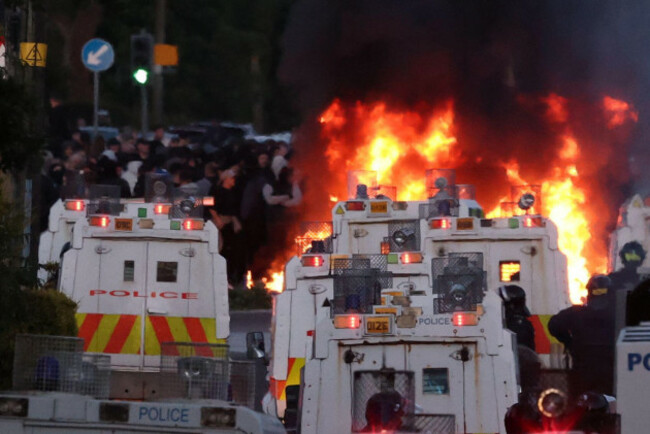 rioters-have-set-fire-to-wheelie-bins-and-removed-a-garden-fence-to-use-as-a-shield-against-a-police-water-cannon-on-antrim-road-at-the-sandyknowes-roundabout-in-newtownabbey-picture-date-wednesday