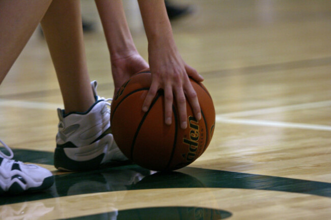 a-basketball-being-picked-up-by-an-unseen-player-so-they-can-throw-it-in-bounds-from-the-baseline-of-the-basketball-court-image-shot-2008-exact-date-unknown