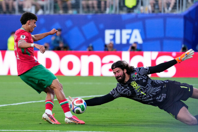 brazil-goalkeeper-alisson-becker-right-makes-a-save-against-moroccos-ayoub-amaimouni-during-the-world-cup-group-c-soccer-match-between-brazil-and-morocco-in-east-rutherford-n-j-near-new-york-sa