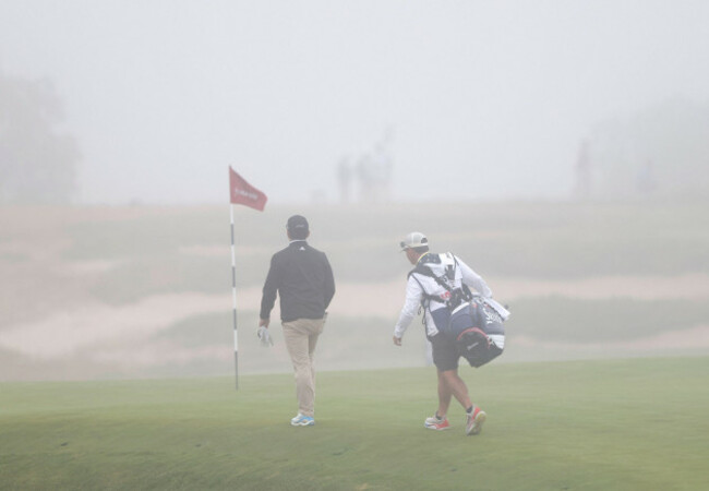 southhampton-united-states-18th-june-2026-alejandro-tosti-of-argentina-walks-with-his-caddie-as-thick-fog-causes-a-delay-in-play-during-the-first-round-of-the-126th-u-s-open-golf-championship-at