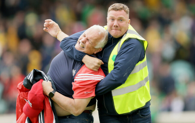 a-steward-tackles-a-cork-fan-on-the-pitch-after-the-game