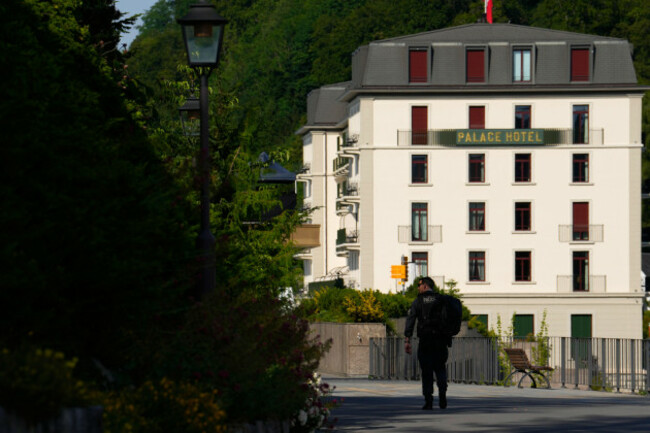 a-member-of-the-us-secret-service-walks-backdropped-by-the-palace-hotel-where-u-s-iran-negotiations-take-place-at-the-burgenstock-resort-in-obbuergen-near-lucerne-in-switzerland-sunday-june-21-2