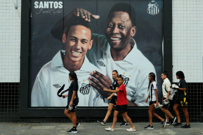 santos-fans-walk-past-a-mural-of-late-football-legend-pele-right-and-neymar-outside-vila-belmiro-stadium-in-santos-brazil-thursday-may-28-2026-ap-photoandre-penner