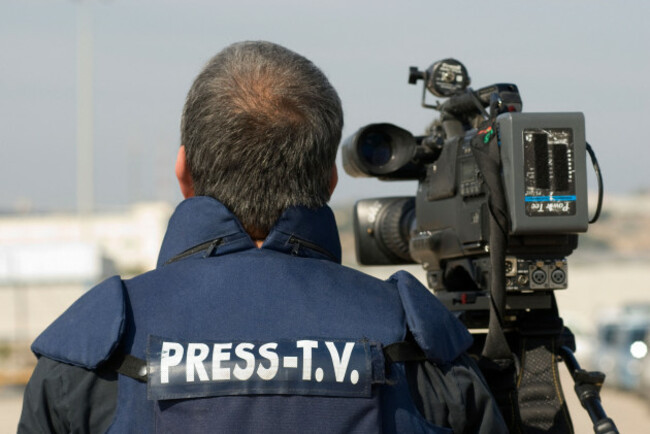 a-tv-news-cameraman-wears-protective-flak-jacket-marked-with-press-tv-near-gaza-border-image-shot-2009-exact-date-unknown