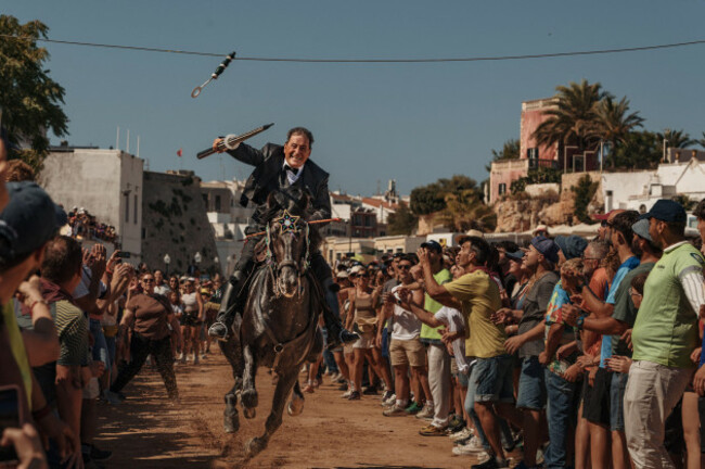 ciutadella-spain-24th-june-2026-a-caixer-horse-rider-aims-his-lance-at-a-suspended-ring-during-the-training-session-for-the-jocs-des-pla-medieval-tournament-during-the-traditional-sant-jo