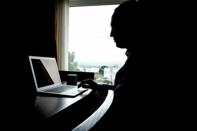 silhouette-of-a-person-using-a-laptop-computer-at-home
