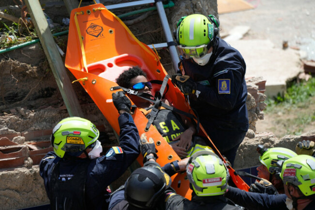 members-of-a-colombian-search-and-rescue-team-pull-moises-calzadilla-11-from-the-rubble-three-days-after-earthquakes-struck-la-guaira-venezuela-saturday-june-27-2026-ap-photofernando-vergara