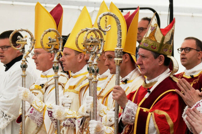newly-consecrated-bishops-from-left-pascal-schreiber-michael-goldade-michel-poinsinet-de-sivry-and-marc-hanappier-wearing-their-miters-and-holding-their-pastoral-staffs-stand-at-the-end-of-their