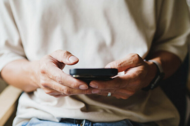 close-up-of-person-looking-at-mobile-phone-online-social-addict