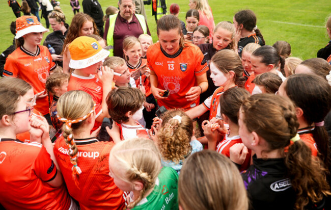 aimee-mackin-takes-pictures-with-fans-after-the-game