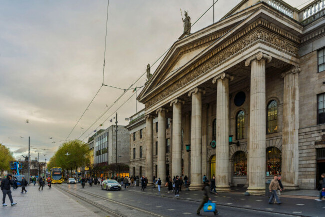 general-post-office-on-oconnell-street-in-dublin-with-pedestrians-traffic-and-tram-tracks-at-this-historic-city-landmark