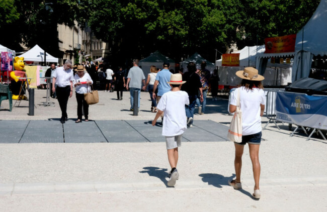woman-and-boy-wearing-shorts-and-hats-during-the-heatwave-in-nimes-france-2026
