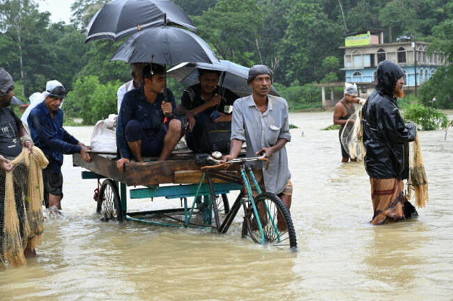 satkania-chattogram-bangladesh-11th-july-2026-july-11-2026-satkania-chattogram-bangladesh-residents-use-carts-and-boats-to-cross-flooded-roads-as-severe-floods-and-landslides-hit-chattogram