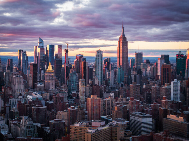 aerial-view-of-the-empire-state-building-piercing-the-skyline-amidst-a-symphony-of-skyscrapers-painted-with-the-warm-hues-of-sunset-new-york-new-york-united-states