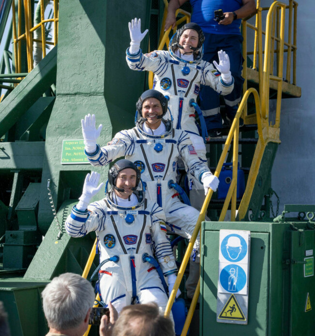 expedition-75-roscosmos-cosmonaut-anna-kikina-top-nasa-astronaut-anil-menon-middle-and-roscosmos-cosmonaut-pyotr-dubrov-bottom-wave-farewell-prior-to-boarding-the-soyuz-ms-29-spacecraft-for-laun