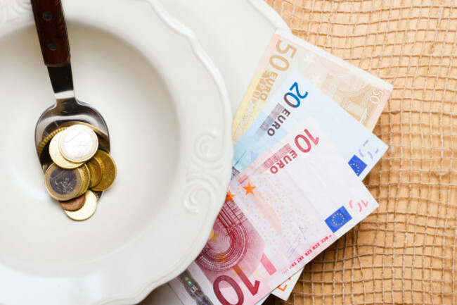 cost-of-living-price-of-food-and-eating-wealth-concept-euro-money-on-kitchen-table-plate-spoon-with-coins-and-banknote