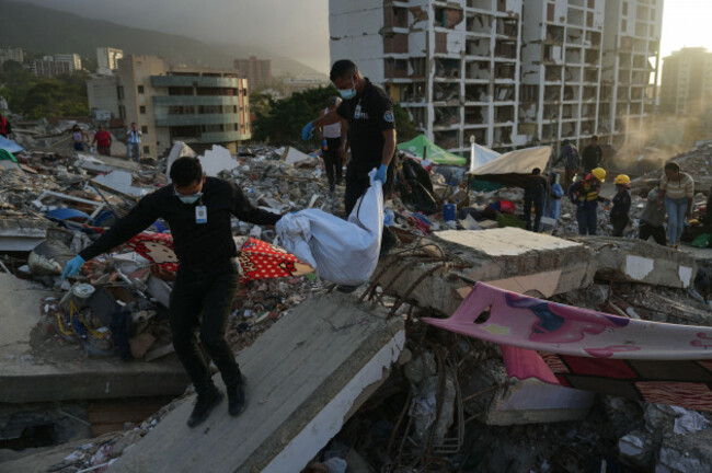 members-of-venezuelas-scientific-penal-and-criminalistic-investigation-corps-recover-the-body-of-one-of-yolimar-torress-two-daughters-whom-the-family-found-themselves-in-the-rubble-of-a-building