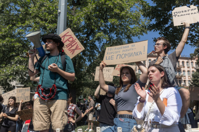 a-protester-speaks-through-a-megaphone-as-demonstrators-hold-signs-reading-firing-someone-for-good-work-is-a-mistake-and-bring-fedorov-back-during-a-rally-opposing-the-dismissal-of-ukrainian-defen