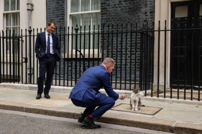 minister-of-state-for-trade-chris-bryant-interacts-with-larry-the-cat-as-parliamentary-under-secretary-of-state-for-the-middle-east-hamish-falconer-left-looks-on-as-they-wait-for-the-arrival-of-gu
