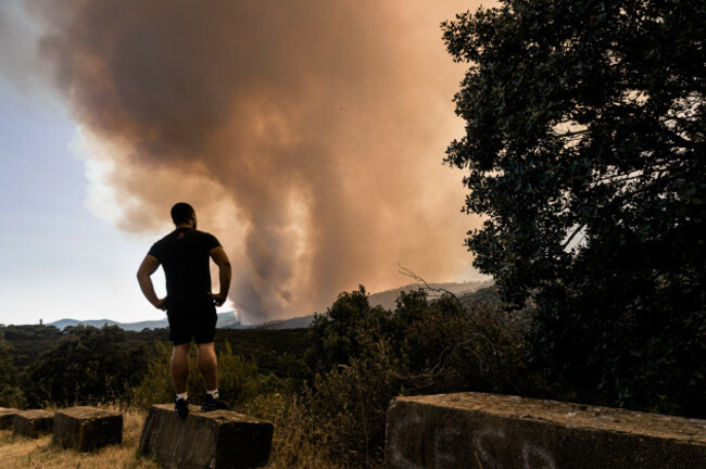a-person-watches-the-fire-spread-on-23-july-2026-in-san-martin-de-valdeiglesias-madrid-spain-a-new-wildfire-broke-out-on-thursday-in-the-community-of-madrid-after-a-car-caught-fire-on-the-m-501-in