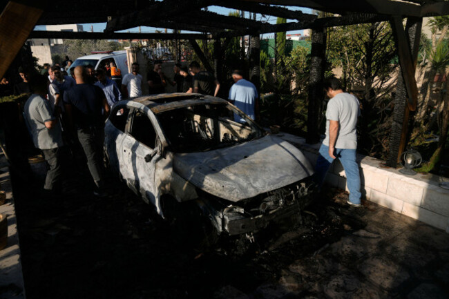 palestinians-stand-next-to-a-burned-car-following-an-attack-by-israeli-settlers-in-the-village-of-sarra-near-the-west-bank-city-of-nablus-friday-july-24-2026-ap-photomajdi-mohammed
