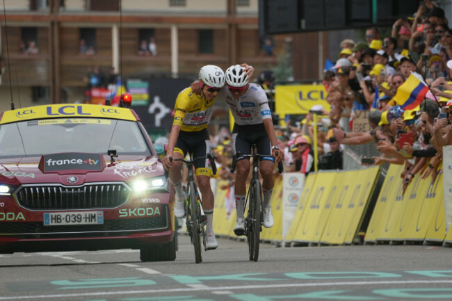 slovenias-tadej-pogacar-left-and-mexicos-isaac-del-toro-right-celebrate-as-they-cross-the-finish-line-of-the-twentieth-stage-of-the-tour-de-france-cycling-race-with-start-in-le-bourg-doisans-an