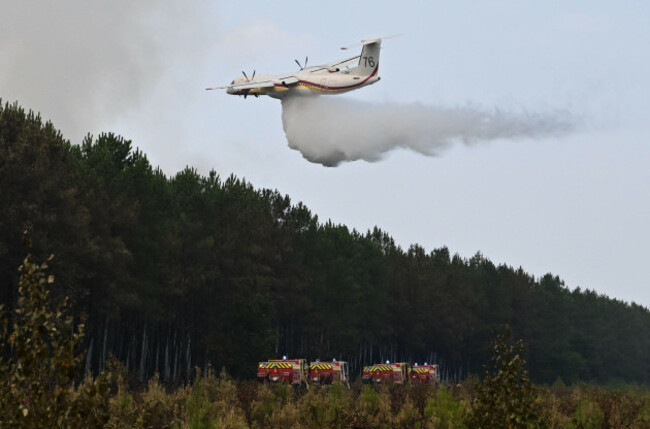a-de-havilland-canada-dhc-8-400-dash-8-operated-by-the-french-civil-defense-agency-drops-fire-retardant-as-wildfires-rage-near-le-las-outside-bordeaux-france-monday-july-27-2026-ap-photoemma-d