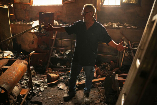 paulino-dominguez-62-checks-his-blacksmith-workshop-burned-by-a-wildfire-in-piedralaves-avila-province-spain-as-the-fire-continues-to-spread-tuesday-july-28-2026-ap-photomanu-fernandez