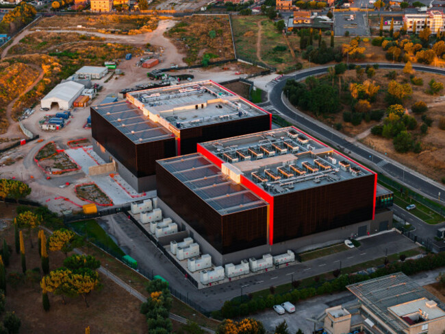 aerial-view-of-a-modern-datacenter-facility-with-large-rectangular-buildings-rooftop-hvac-units-and-surrounding-infrastructure-in-settecamini-lazio