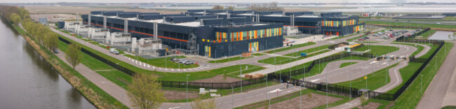 aerial-view-of-a-large-modern-data-center-campus-with-industrial-buildings-back-up-energy-systems-and-parking-areas-situated-in-the-polder-landscape